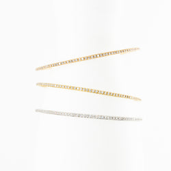 Three bangle bracelets in white gold, yellow gold, rose gold, and diamonds