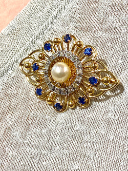 Gold brooch with sapphires, a pearl, and diamonds