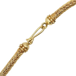 Necklace in braided gold with ram's head motifs diamonds and rubies