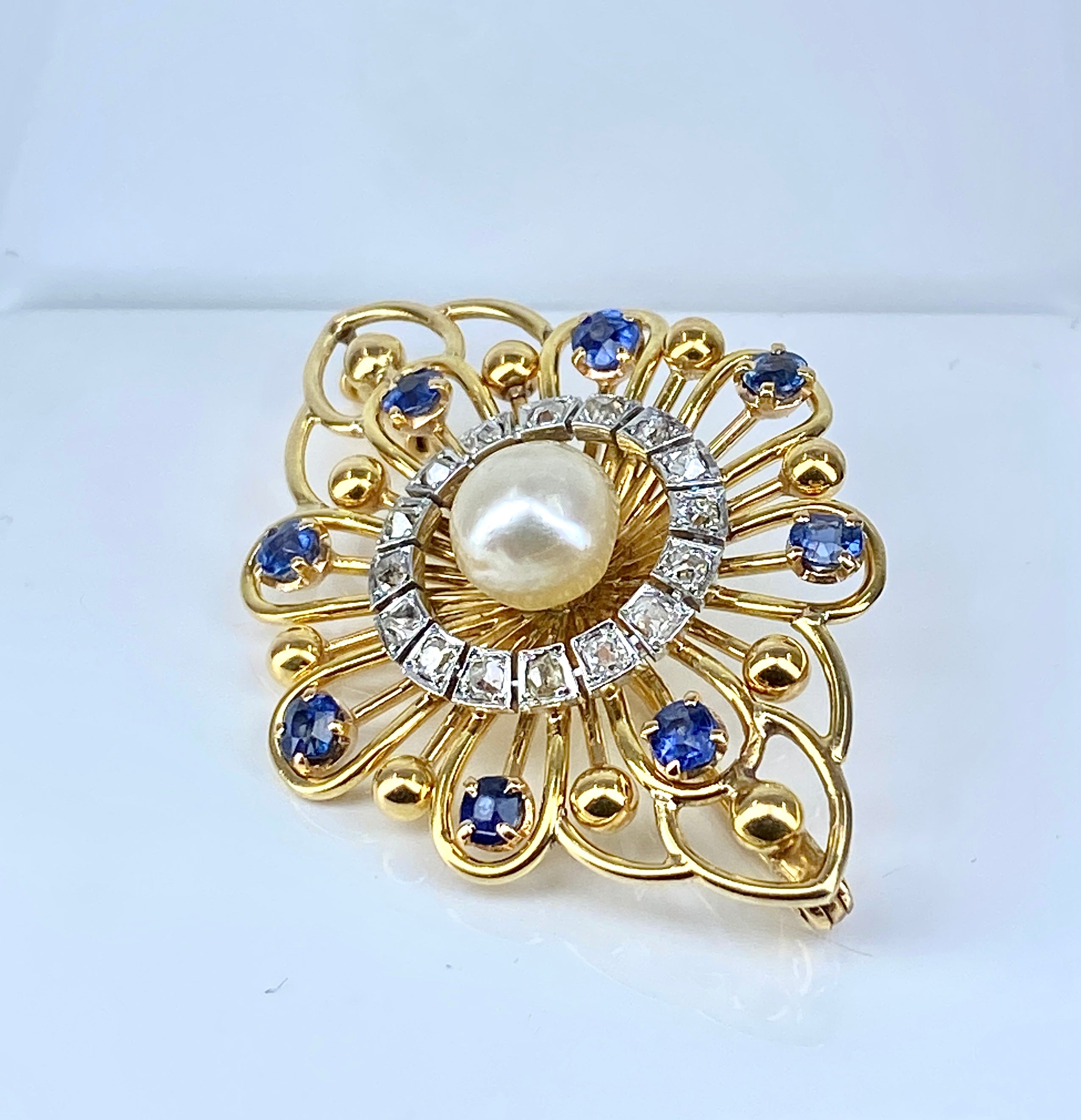 Gold brooch with sapphires, a pearl, and diamonds