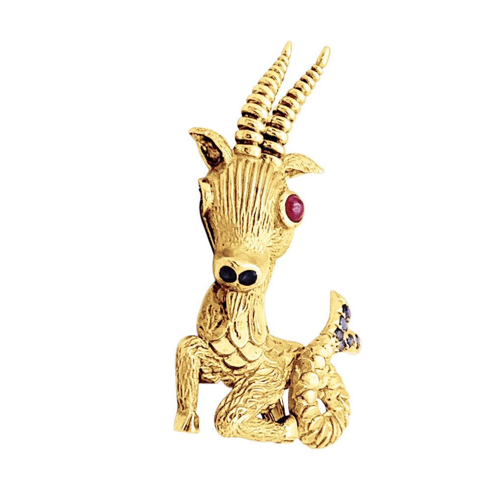 Broche-clip, "Capricorne", or jaune, rubis, saphirs.