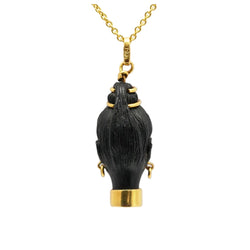 Yellow gold, ebony, and turquoise pendant