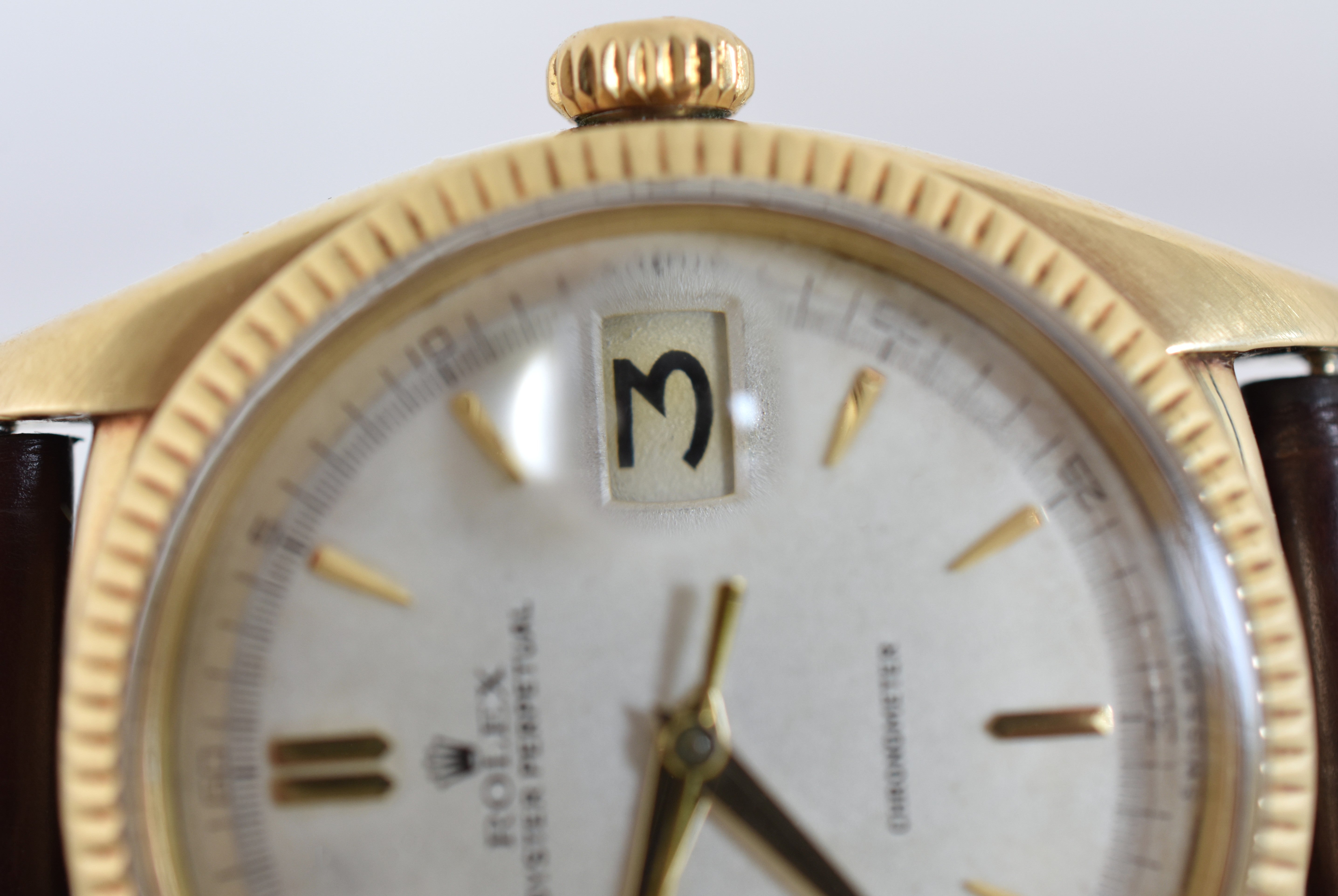 ROLEX "Oyster Perpetual Date Ovettone" watch in yellow gold and leather
