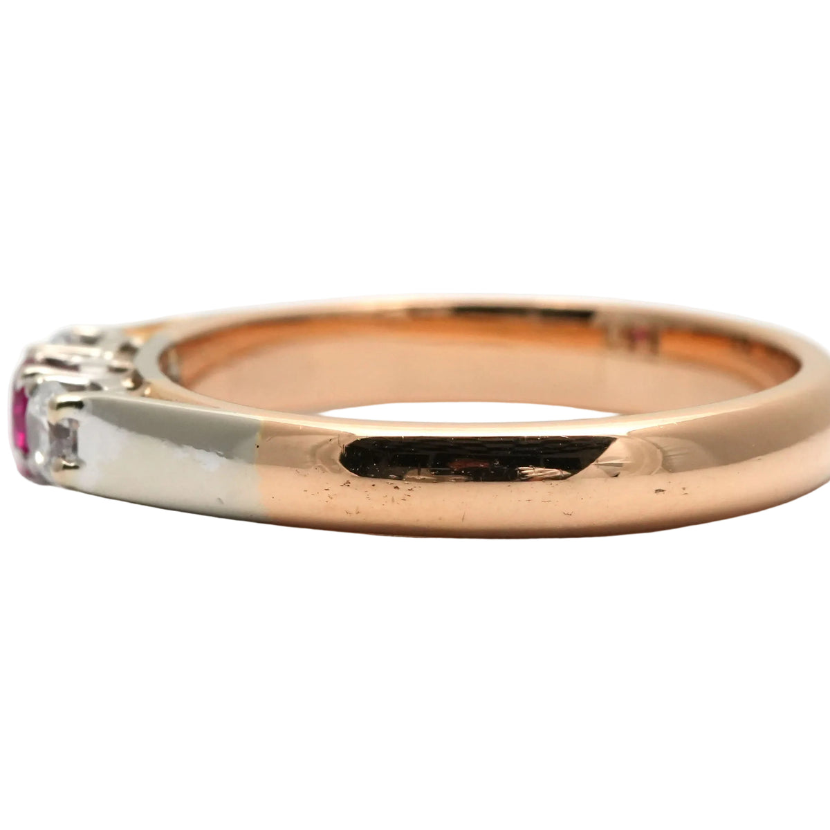 Trilogy Ring in white gold, yellow gold, rubies, and diamonds