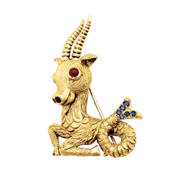 Broche-clip, "Capricorne", or jaune, rubis, saphirs.