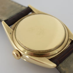 ROLEX "Oyster Perpetual Date Ovettone" watch in yellow gold and leather