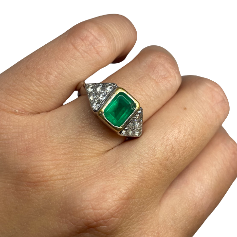 Ring in white gold, yellow gold, emerald, and diamonds