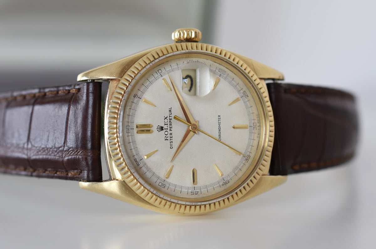 ROLEX "Oyster Perpetual Date Ovettone" watch in yellow gold and leather