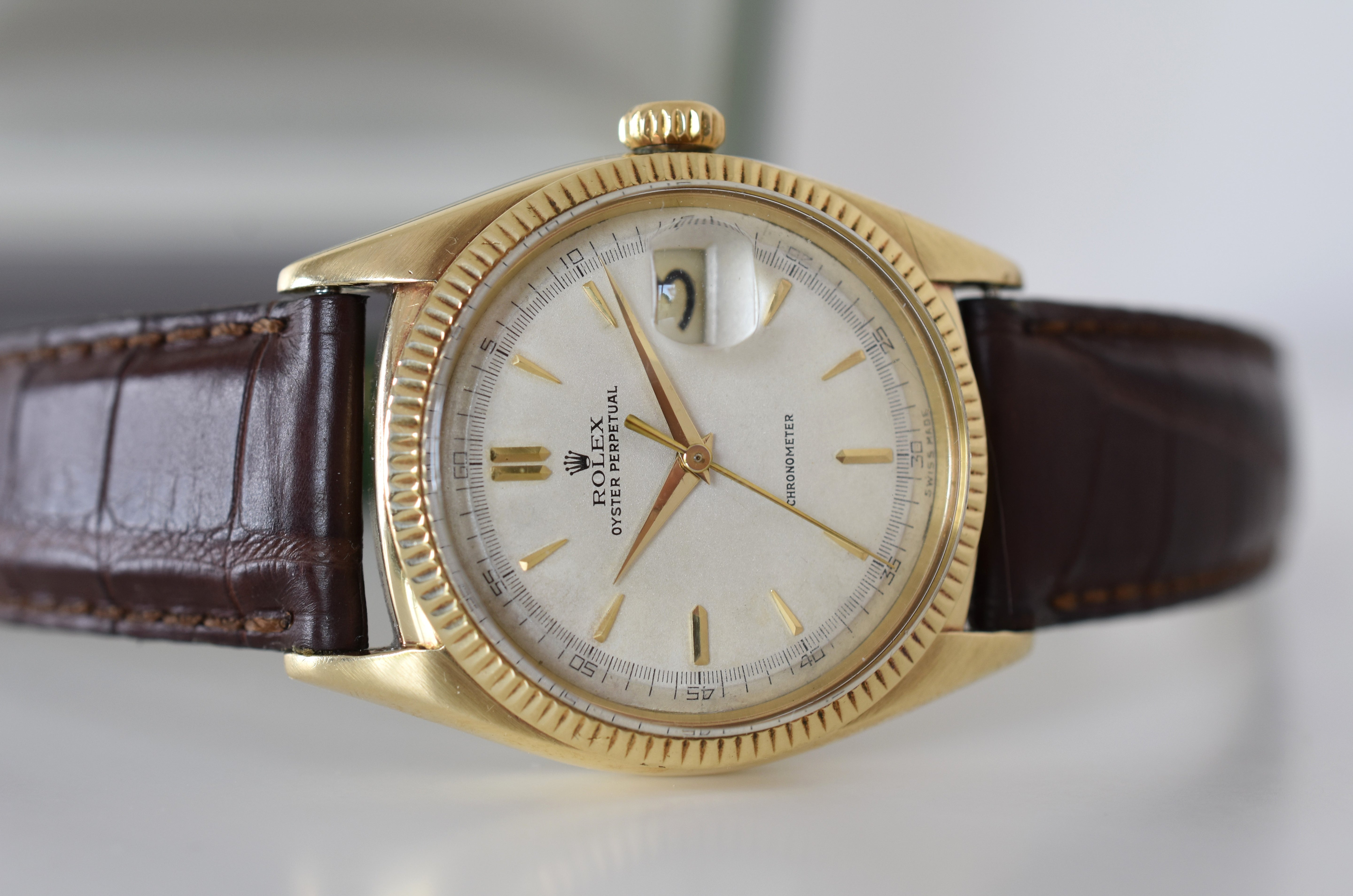 ROLEX "Oyster Perpetual Date Ovettone" watch in yellow gold and leather