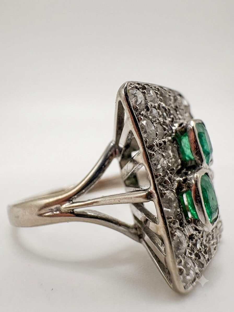 White gold ring with emeralds and diamonds