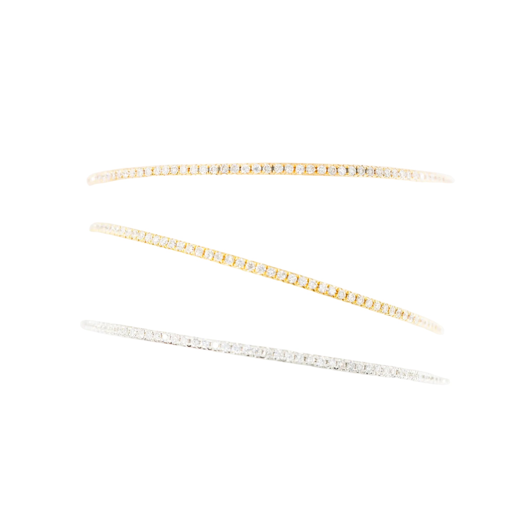 Three bangle bracelets in white gold, yellow gold, rose gold, and diamonds