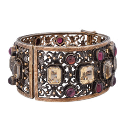 Cuff bracelet in yellow gold, silver, beryls, and garnets