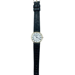 BAUME & MERCIER Watch in yellow gold and leather