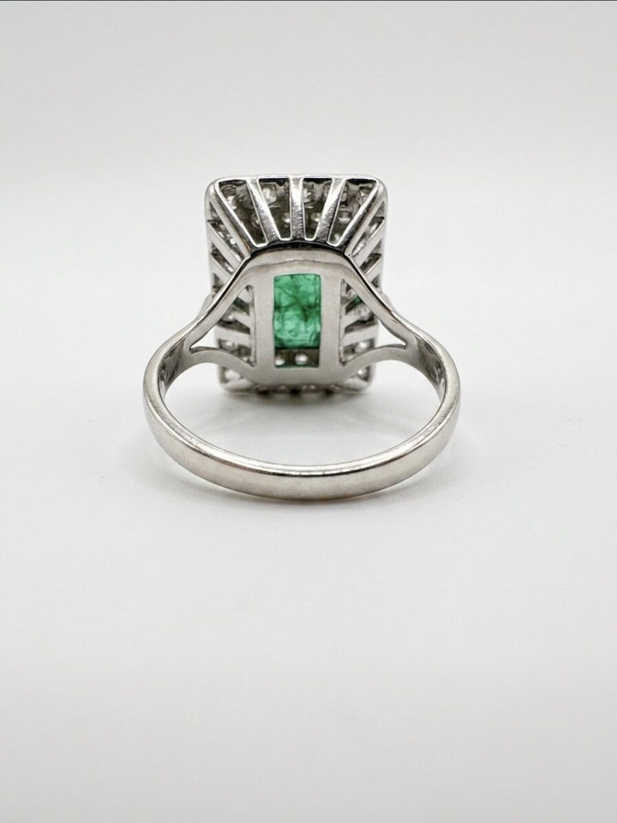 White gold ring with emeralds and diamonds