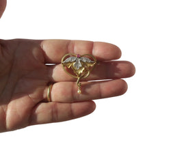 Art Nouveau Brooch Pendant with Rubies, Diamonds, and a Fine Pearl in 18-carat Rose Gold and Platinum