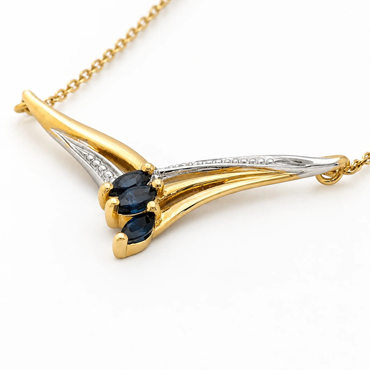 Necklace with a pendant in white gold, yellow gold, sapphires, and a diamond