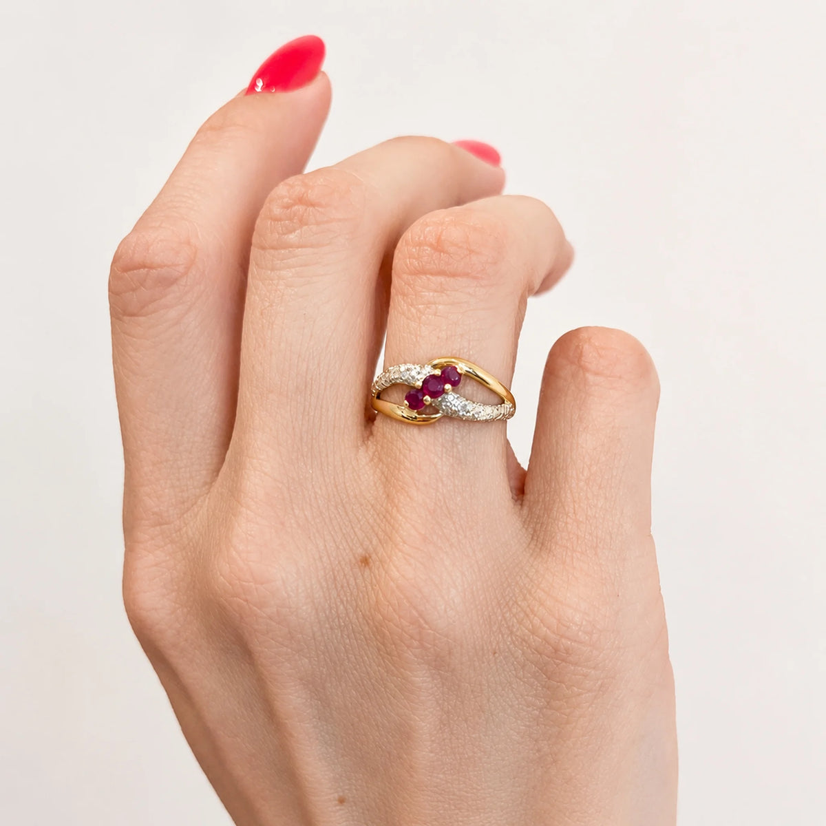 Ring in white gold, yellow gold, rubies, and diamonds