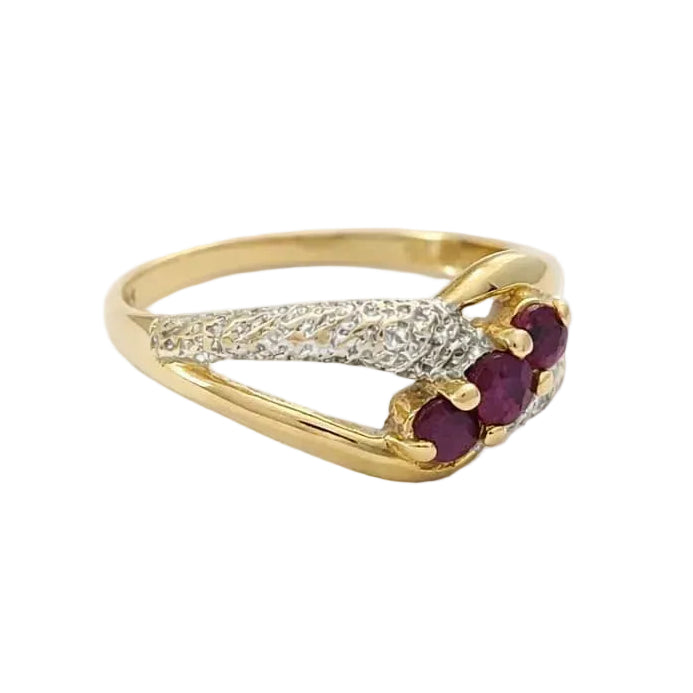 Ring in white gold, yellow gold, rubies, and diamonds