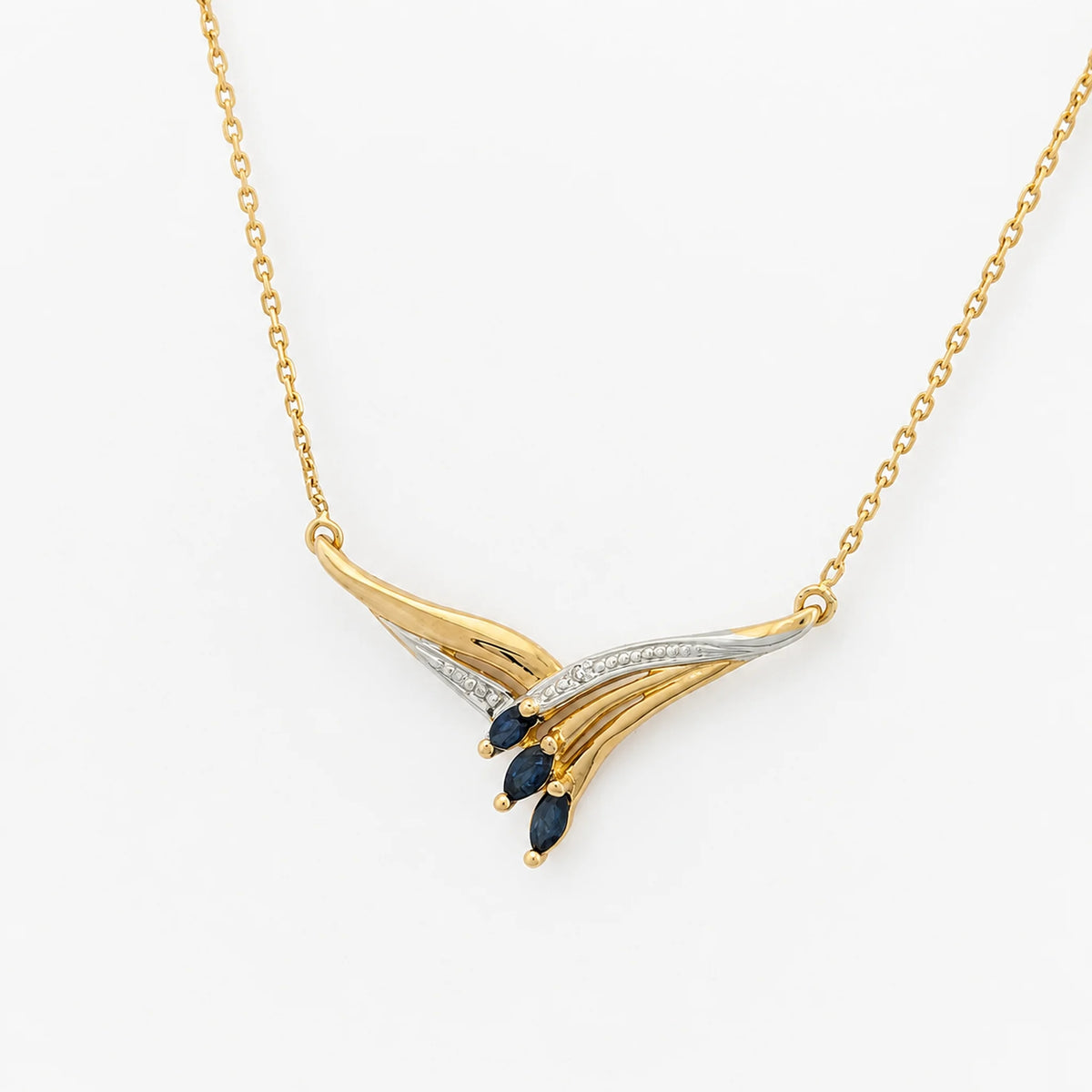 Necklace with a pendant in white gold, yellow gold, sapphires, and a diamond