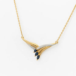 Necklace with a pendant in white gold, yellow gold, sapphires, and a diamond