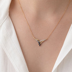 Necklace with a pendant in white gold, yellow gold, sapphires, and a diamond