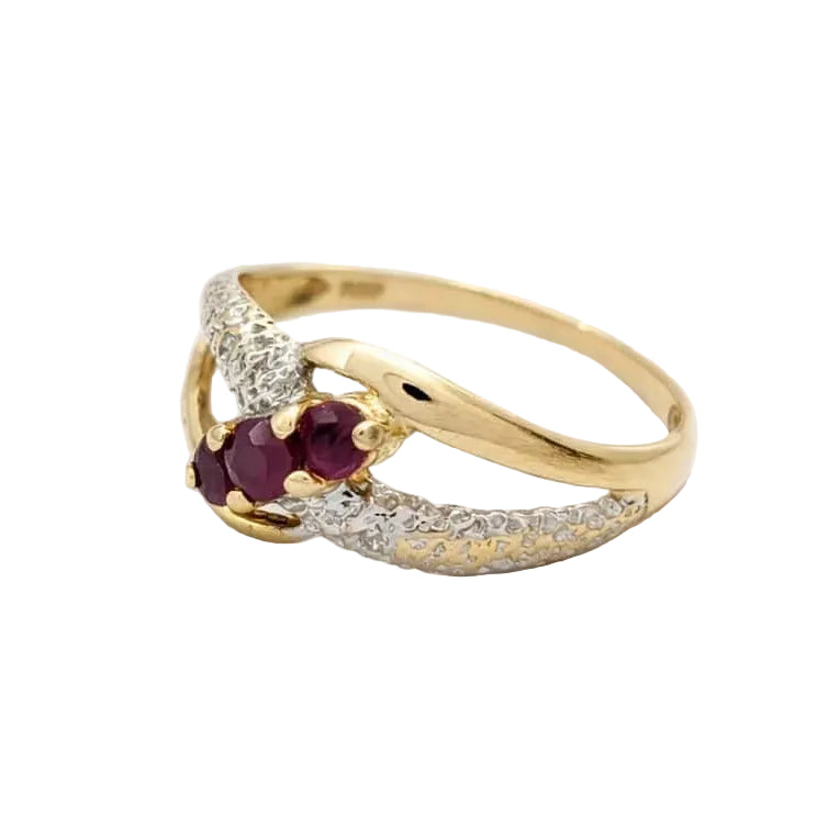 Ring in white gold, yellow gold, rubies, and diamonds
