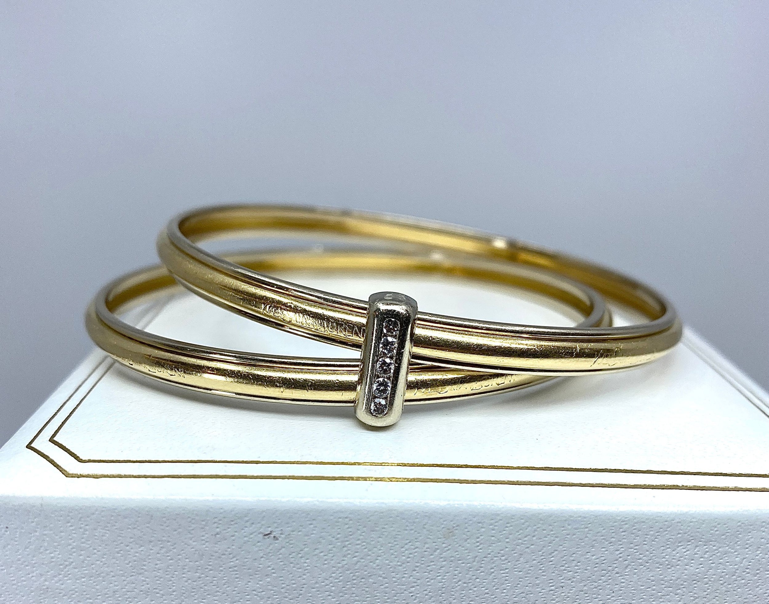 Bracelet double joncs or 18 carats, diamants, Yves Saint Laurent