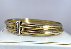 Bracelet double joncs or 18 carats, diamants, Yves Saint Laurent