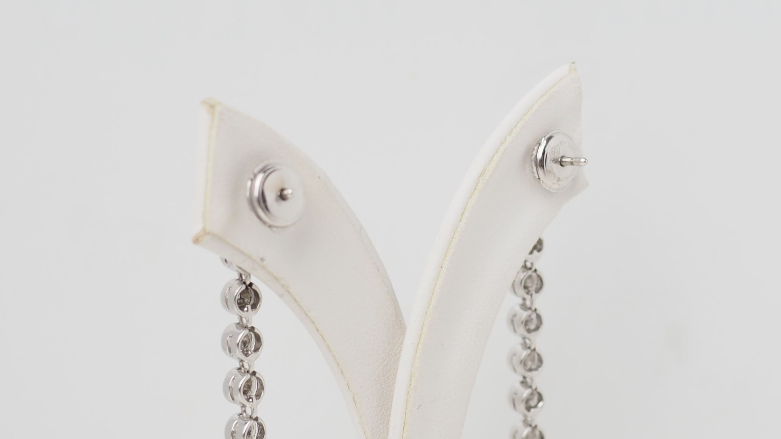 White gold and diamond dangling earrings