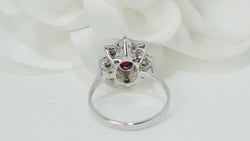 White gold, oval ruby and diamond entourage ring