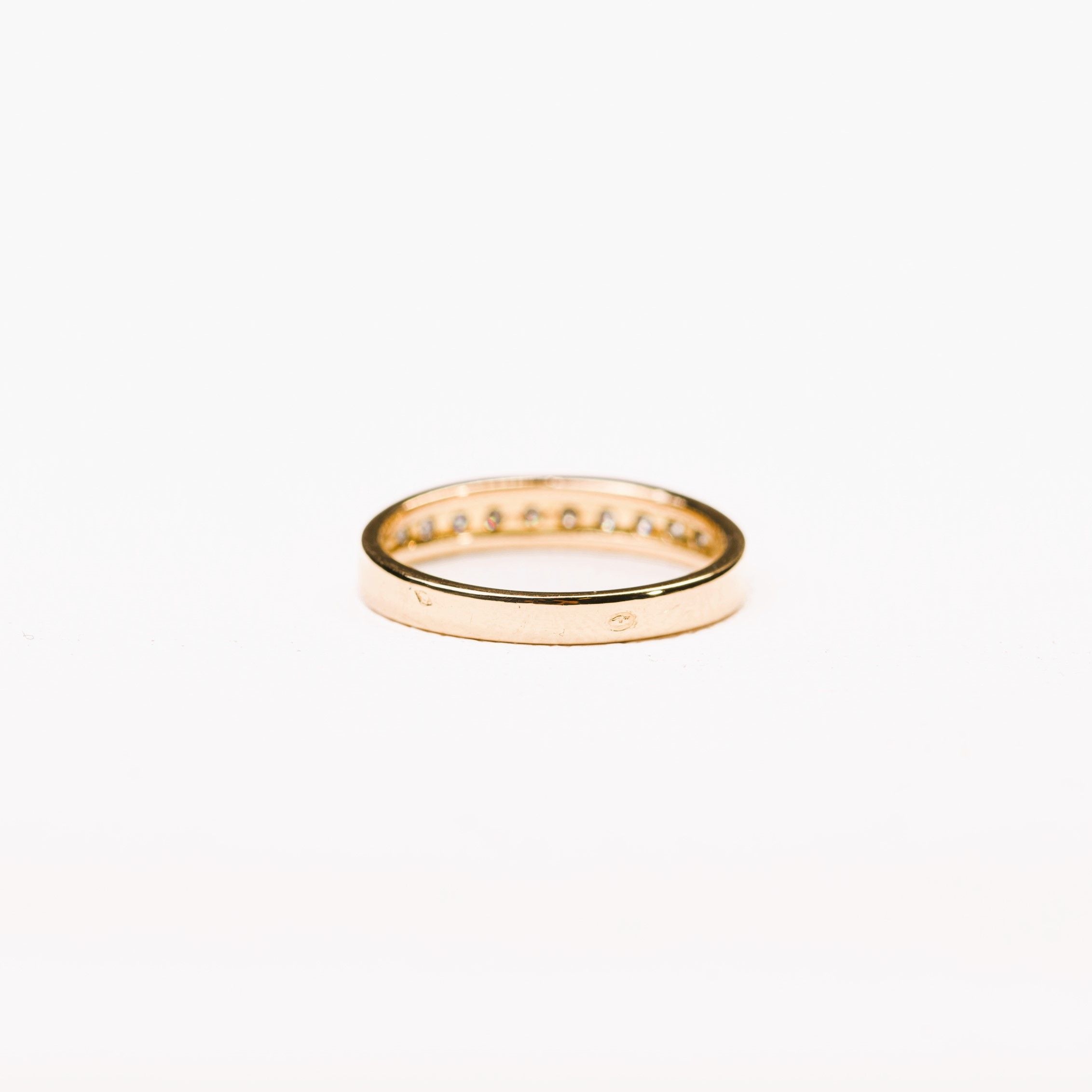 Half-eternity diamond wedding band in yellow gold