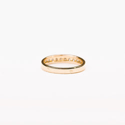 Half-eternity diamond wedding band in yellow gold