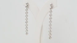 White gold and diamond dangling earrings