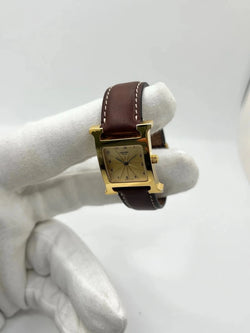 Montre HERMÈS "Heure H" plaqué or, acier et cuir - Castafiore