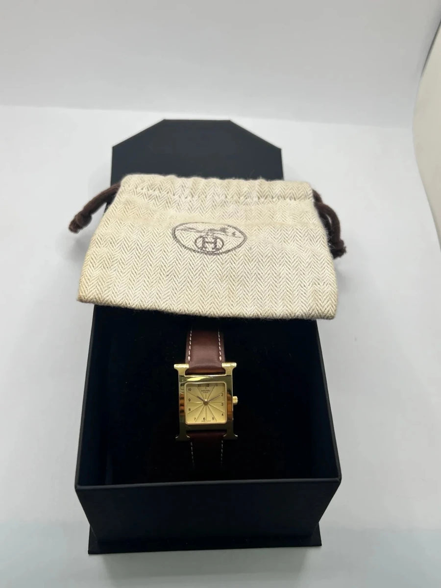 Montre HERMÈS "Heure H" plaqué or, acier et cuir - Castafiore
