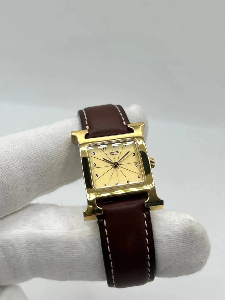 Montre HERMÈS "Heure H" plaqué or, acier et cuir - Castafiore
