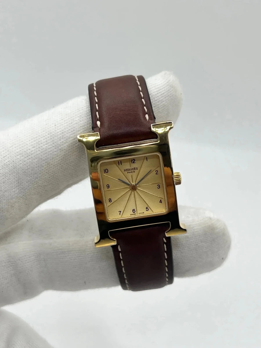 Montre HERMÈS "Heure H" plaqué or, acier et cuir - Castafiore