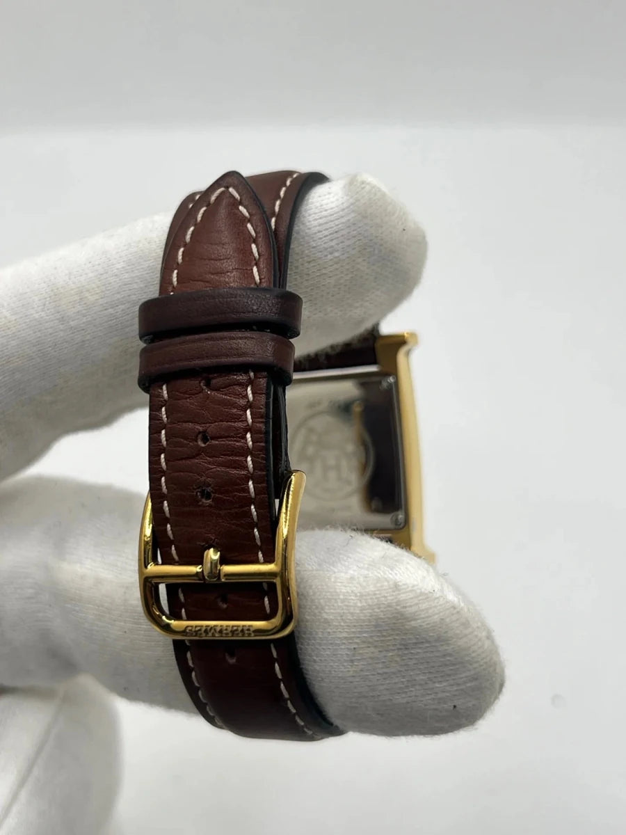 Montre HERMÈS "Heure H" plaqué or, acier et cuir - Castafiore
