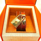 Montre Hermès Kelly , cadran PM plaqué or, double tour de poignet cuir marron - Castafiore