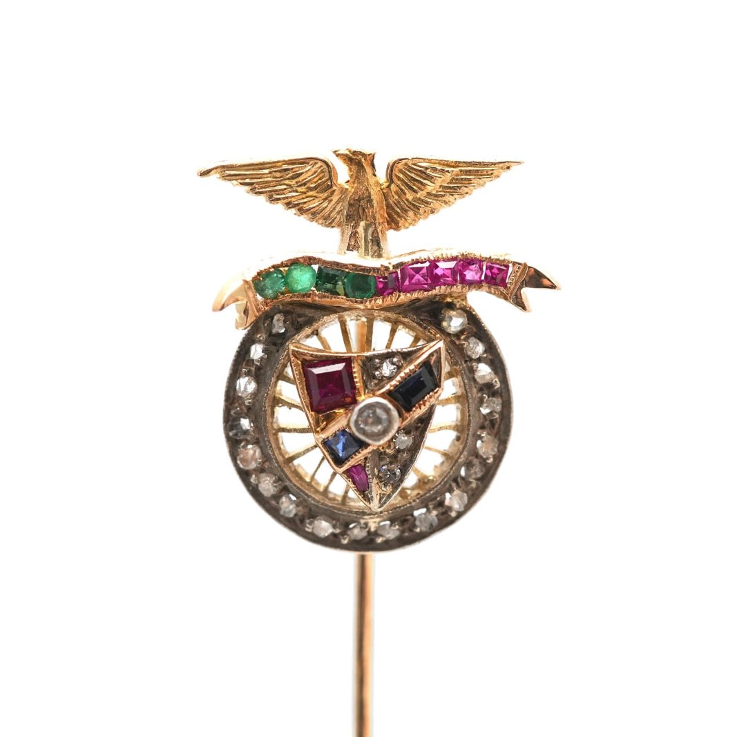 Pique à cravate en or jaune, saphirs, grenats, émeraudes et diamants - Castafiore