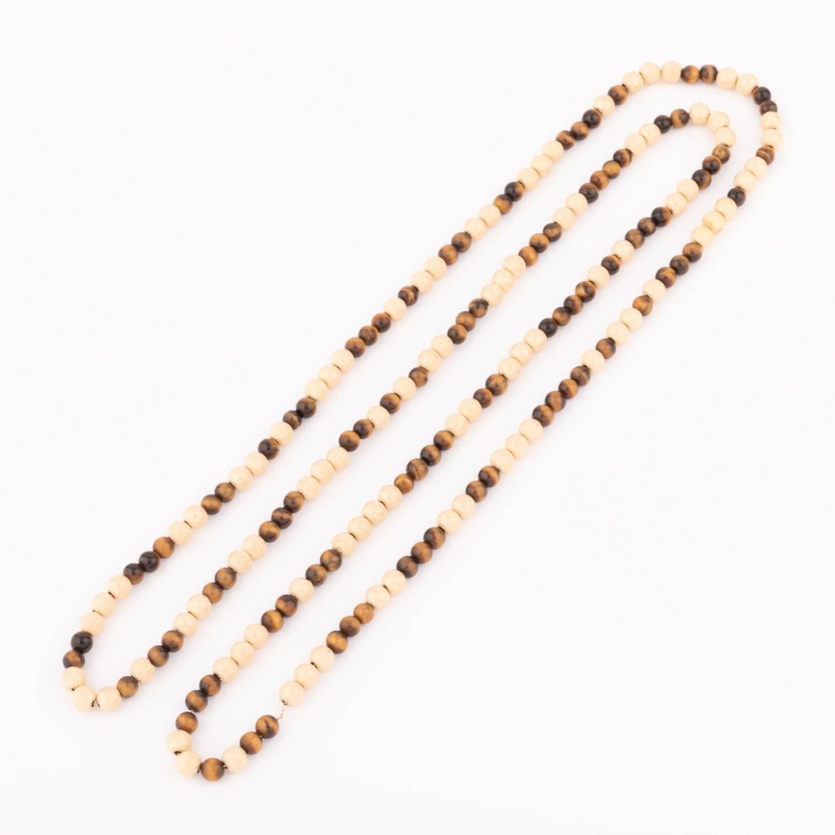 Sautoir en perles d'or ciselés et perle yeux de tigre - Castafiore