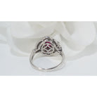 Bague entourage en platine, rubis ovale et diamants - Castafiore