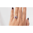 Bague entourage en platine, rubis ovale et diamants - Castafiore