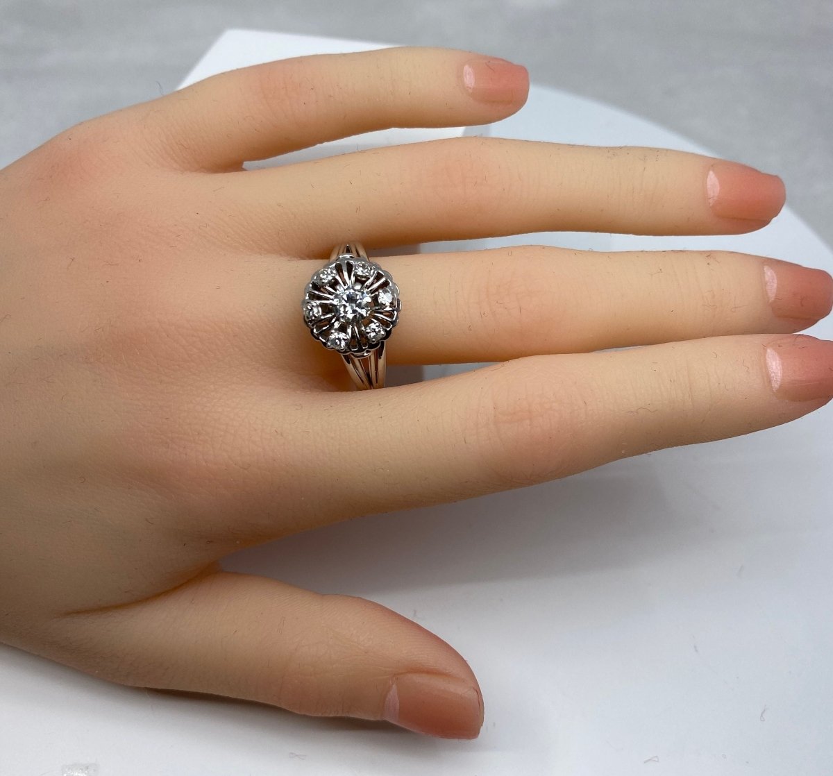 Bague ronde en or 18 carats marguerite sertie de 7 diamants de taille brillant - Castafiore