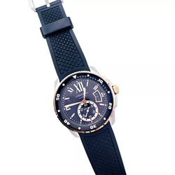 Montre Cartier Calibre en or et acier sur bracelet caoutchouc. - Castafiore